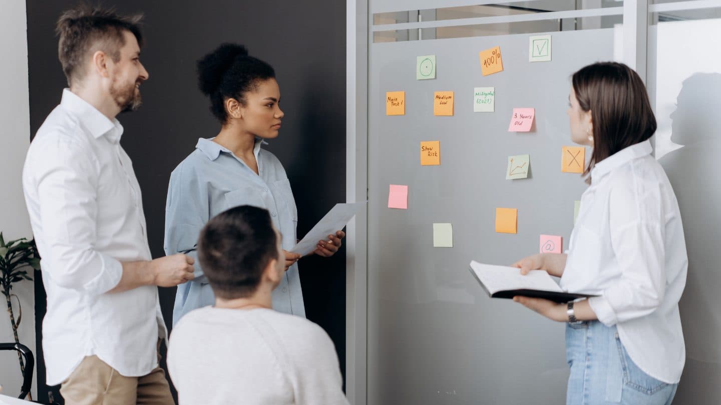 Product team mapping a vision and roadmap on a whiteboard